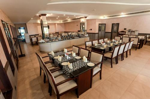 an overhead view of a restaurant with tables and chairs at Renai Blue Waters Cherai in Cherai Beach