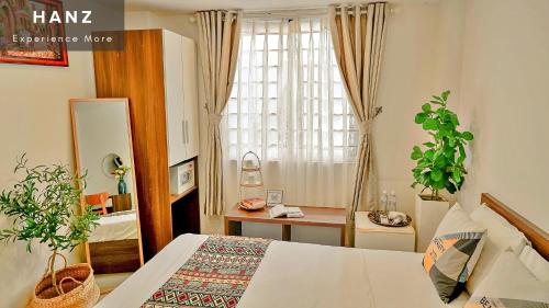 een slaapkamer met een bed en een raam bij HANZ The Galaxy Hotel in Ho Chi Minh-stad