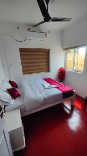 a bedroom with a large bed with a ceiling at Tripsea Beach Villa in Alleppey