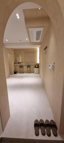 a room with two pairs of shoes on the floor at Island Stay in Jeju