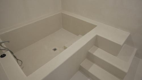 a bathroom with white walls and a white floor at Island Stay in Jeju