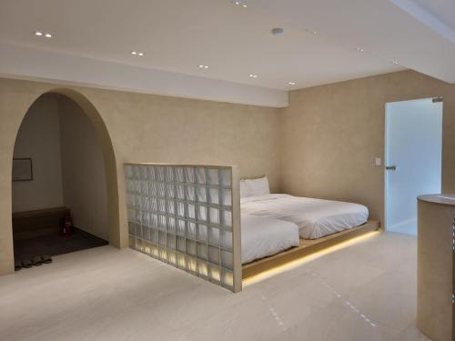a bedroom with a bed with a built in shelf at Island Stay in Jeju