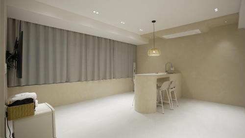 a room with a stage with a table and chairs at Island Stay in Jeju