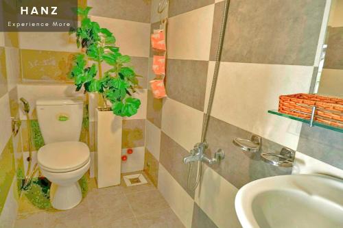 a bathroom with a toilet and a sink at HANZ The Galaxy Hotel in Ho Chi Minh City