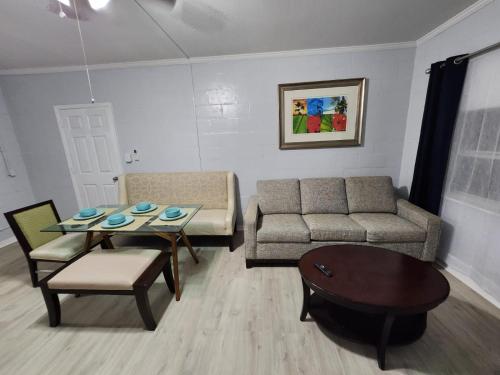 a living room with a couch and a table at Cozy Place in Old Seminole Heights + 2 Queen + 1Sofa Bed in Tampa