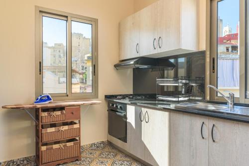 a kitchen with a sink and a stove at 961 Station Apartments in Mar Mikhael in Beirut