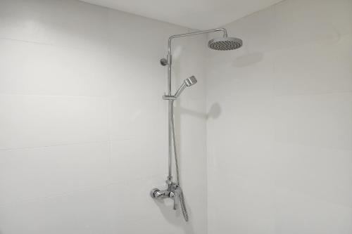 a shower with a shower head in a bathroom at Arsh Boutique Hotel in Chiang Mai