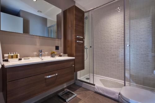 a bathroom with a sink and a shower at Fraser Place Antasya Istanbul in Istanbul