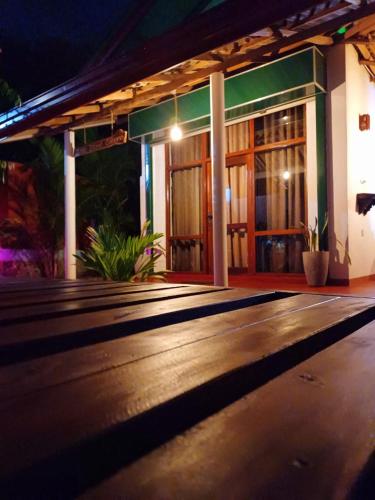 a night view of a building with a wooden floor at Turtle Island Cabana in Tangalle