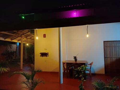 a dining room with a table and a purple light at Turtle Island Cabana in Tangalle