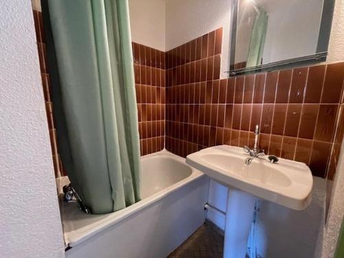 La salle de bains est pourvue d'un lavabo, d'un rideau de douche et d'une baignoire. dans l'établissement 5110 Hermitage 182, au Cap d'Agde