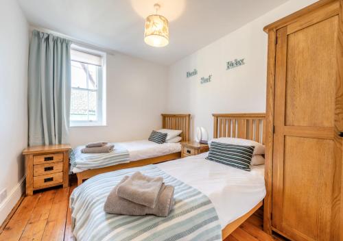 a bedroom with two beds and a window at South Street Farm in Braunton