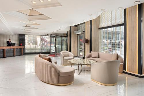 a lobby with couches and a table and windows at Golden Age Hotel Taksim in Istanbul