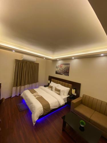 a bedroom with a large bed and a couch at XCELSIOR HOTEL & SPA in Shillong