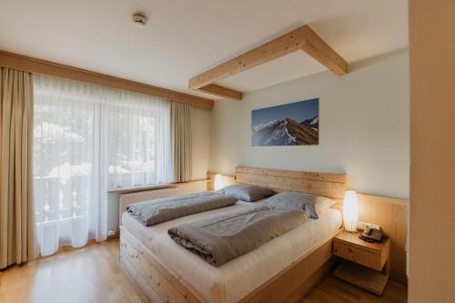 a bedroom with a large bed and a mountain at Parkhotel Matrei in Matrei am Brenner
