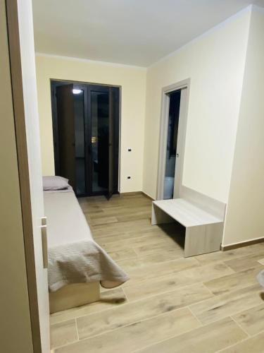 a white room with two beds and a mirror at Sogni d'insonnia in San Sosti