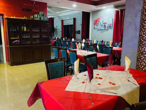 a restaurant with tables and chairs with red table cloth at Sogni d'insonnia in San Sosti