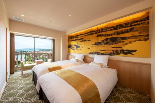 two beds in a room with a large window at Hotel Okura JR Huis Ten Bosch in Sasebo