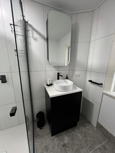 a bathroom with a sink and a mirror at Sans Souci Apartments in Ingham