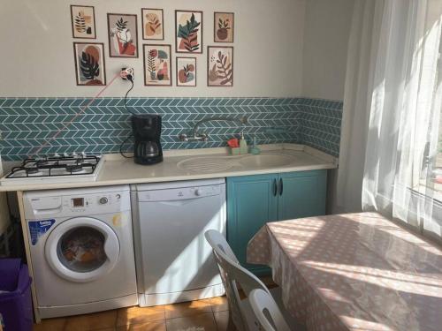 een keuken met een wasmachine en een wastafel bij A Peacefull Terrace at the heart of Ankara in Ankara