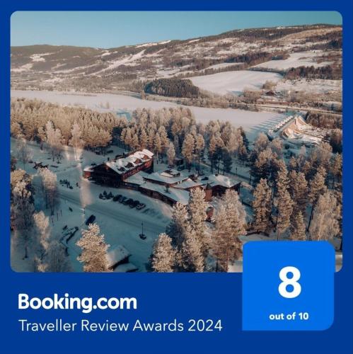 a train traveling through a snow covered forest at Hunderfossen Hotel & Resort in Hafjell