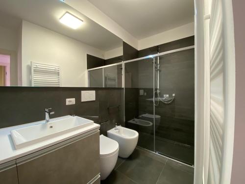 a bathroom with a sink and a toilet and a shower at Charming Apts - Via Pastrengo in Porto Recanati