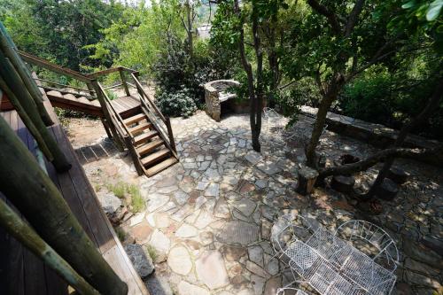 a stairway in a garden with a bench and trees at Rustic River & Bush Escape in Buffelspoort