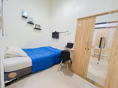 a bedroom with a bed and a sliding glass door at Beranda Istirahat Grogol in Jakarta
