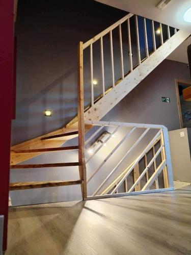 a wooden staircase in a room with a wall at Le Coin Rocheux in La Roche-en-Ardenne