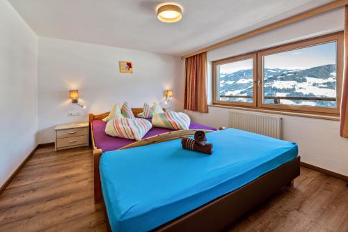 a bedroom with a bed and a large window at App 20 Personen Innerspielleiten in Hippach