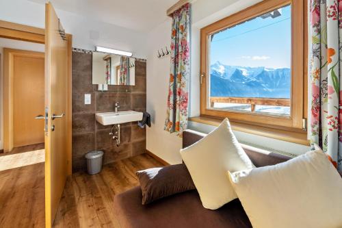 a room with a window and a couch and a sink at App 20 Personen Innerspielleiten in Hippach