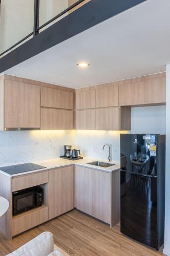 a kitchen with a sink and a counter top at Ramada Plaza by Wyndham Bangkok Sukhumvit 48 in Bangkok
