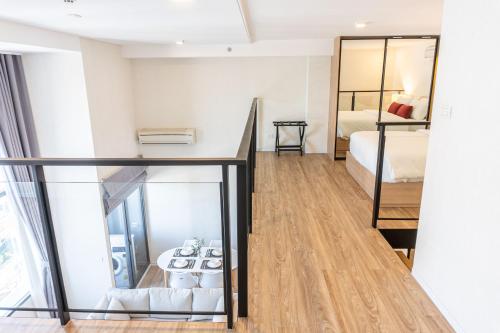a small room with a bed and a mirror at Ramada Plaza by Wyndham Bangkok Sukhumvit 48 in Bangkok