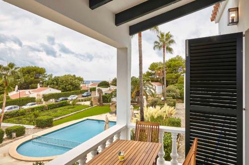 a view from the balcony of a house with a swimming pool at OasisBlanc Binibeca in Binibeca