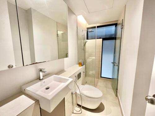 a white bathroom with a sink and a toilet at LA 1-10 Pax Cozy Home Tropicana 3Rooms 4QBeds Wifi&TV in Petaling Jaya