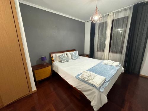 a bedroom with a bed with towels on it at FUNCHAL APARTMENT WITH POOL - Garajau 2 in Caniço