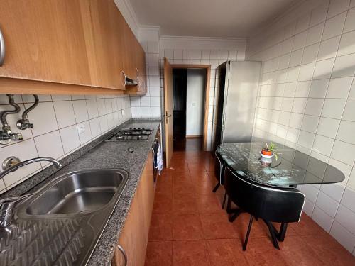 a kitchen with a sink and a counter top at FUNCHAL APARTMENT WITH POOL - Garajau 2 in Caniço