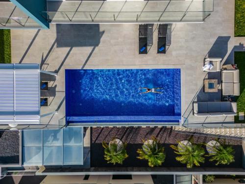 an overhead view of a pool with a person swimming in it at Villa Boa Nova Branca by LovelyStay in Funchal