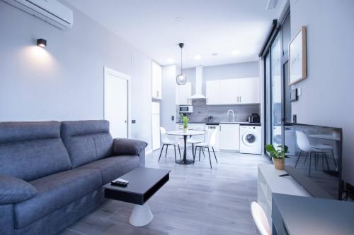 a living room with a couch and a table at Patacona by Concept Flats in Valencia