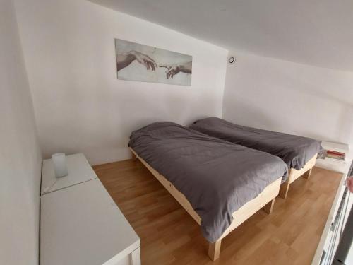 a bedroom with two beds and a table at Gite Europa in Le Mas
