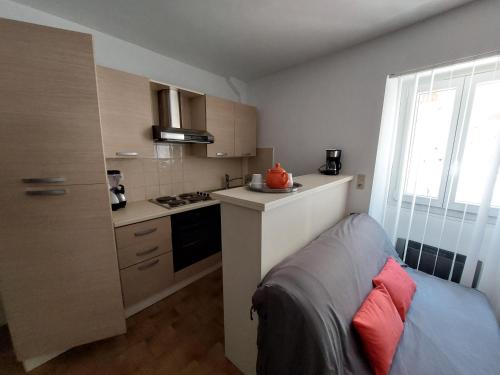 a small kitchen with a sink and a stove at Chardon in Le Mas