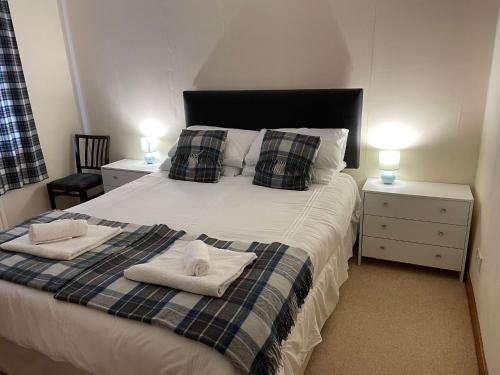 a bedroom with a large bed with towels on it at Dog friendly 6- Bedroom House in Isle of Lewis - great for families and large groups in Garrabost