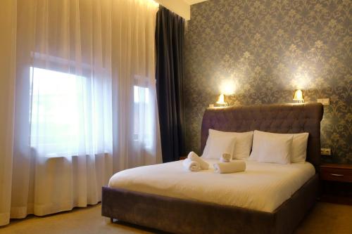 a bedroom with a bed with two towels on it at Black Gold Center in Chorzów