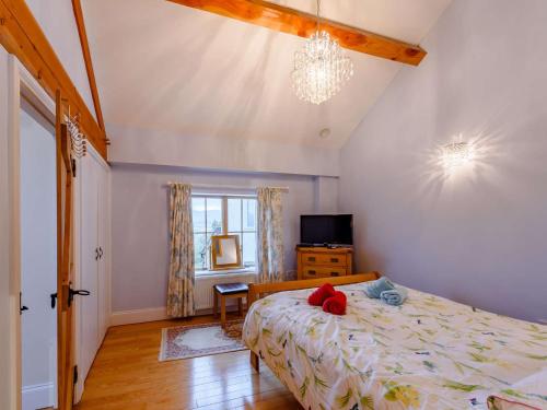 a bedroom with a bed with a red stuffed animal on it at 2 Bed in Conwy 74147 in Eglwys-Fâch