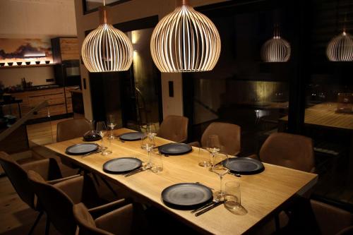 a table in a restaurant with plates and wine glasses at Alpenlodges in Schönau am Königssee