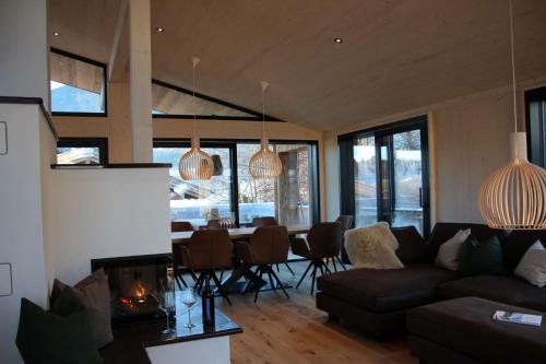 a living room with a couch and a table at Alpenlodges in Schönau am Königssee