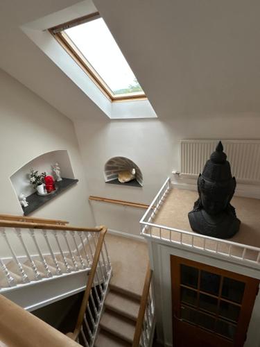an attic room with a skylight and stairs at Awakening Alchemy Retreat Centre in Inverurie