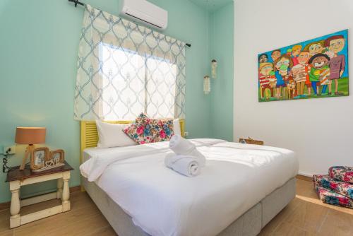 a bedroom with a bed with a white towel on it at 961 Station Apartments in Mar Mikhael in Beirut