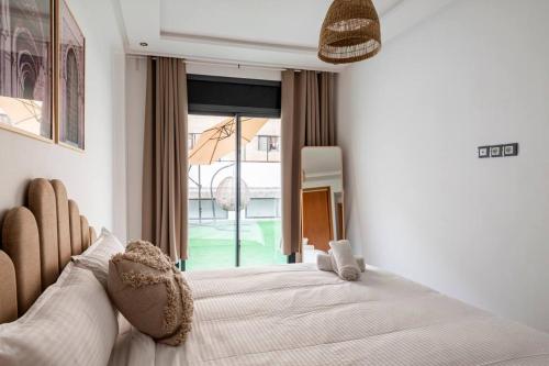 a bedroom with a large bed with a large window at TT Holidays Cosy apartment Rabat City Center in Rabat