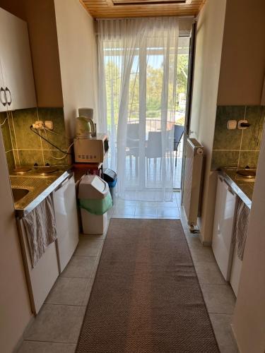 a kitchen with a hallway leading to a door at VillaBoglár in Balatonboglár